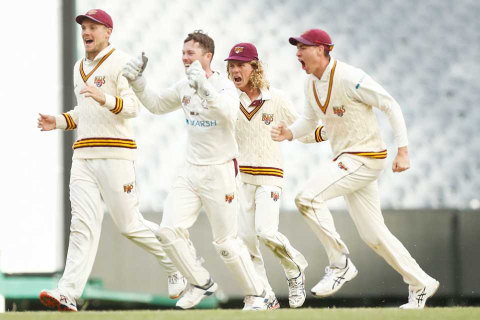 The Queensland players celebrate their win