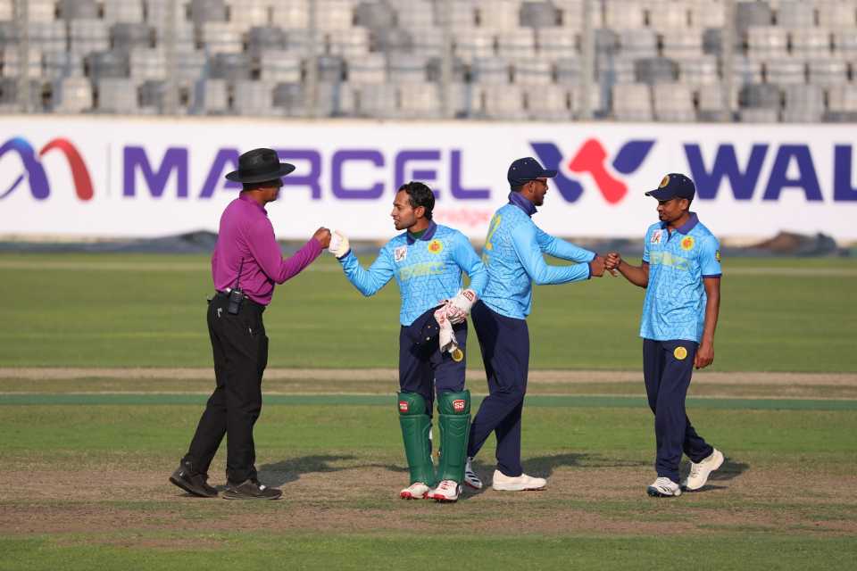 Look Ma, no hands! Mushfiqur Rahim exchanges a fist bump with the umpire