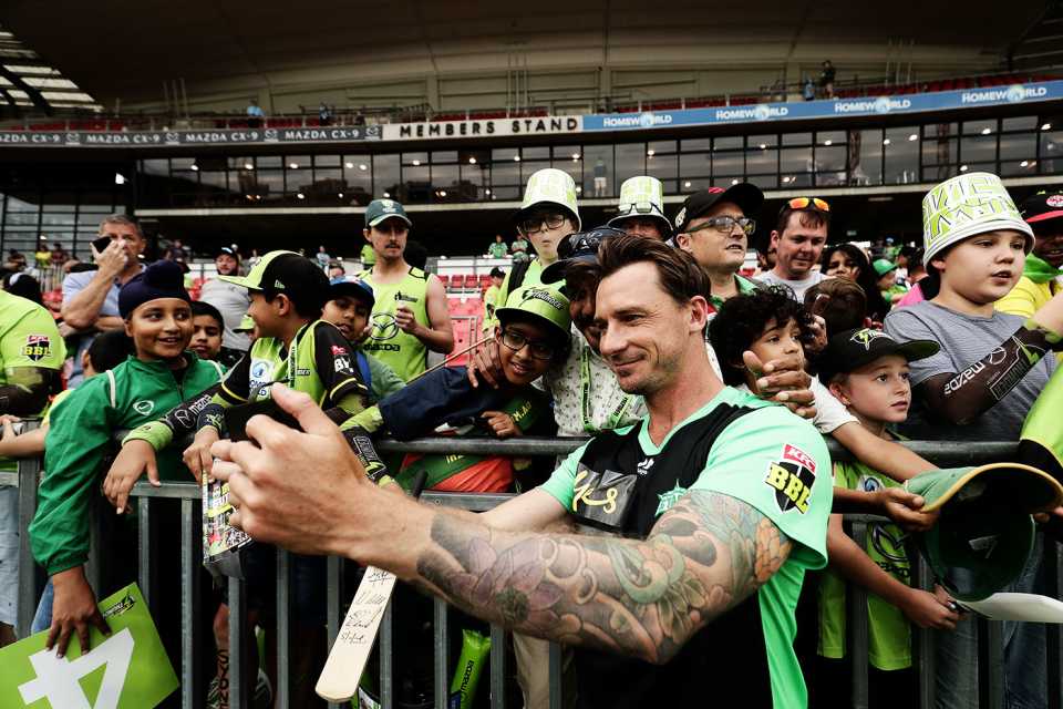 Dale Steyn takes a photo with young fans