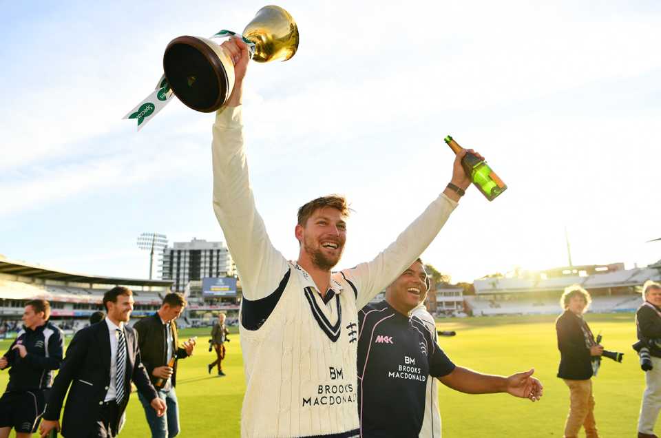 Ollie Rayner holds the County Championship trophy aloft in 2016