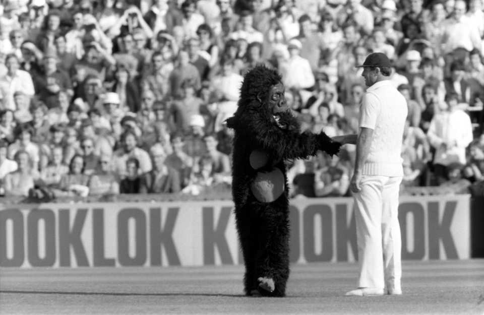 Geoff Boycott laughs as a fan dressed in a gorilla suit comes up to shake his hand