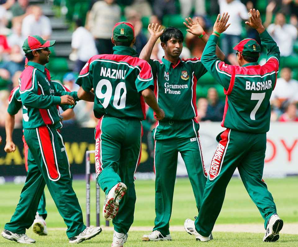 Tapash Baisya celebrates a wicket with his team-mates