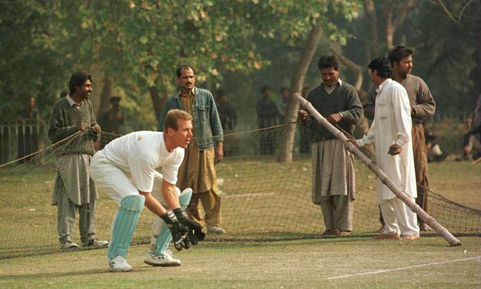 Alec Stewart keeps during practice as the local groundsmen construct the nets, Bagh-e-Jinnah ground, Lahore, Pakistan, Feb 5, 1996