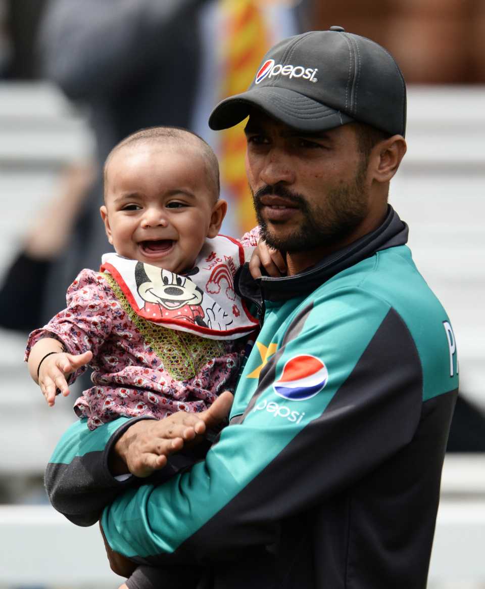 Mohammad Amir holds his daughter