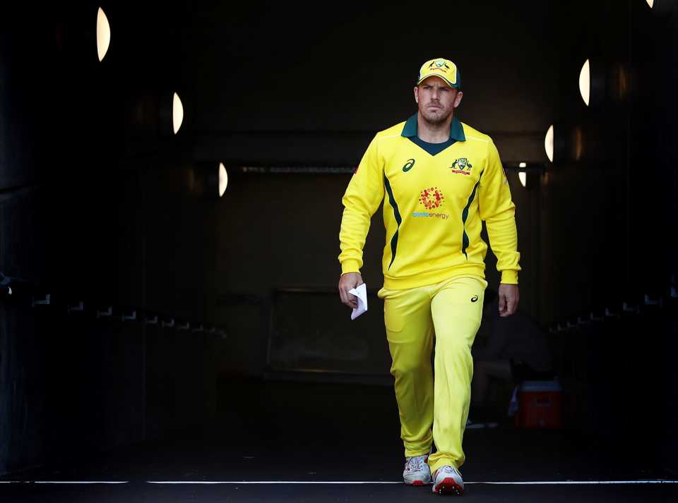 Aaron Finch walks out for the toss