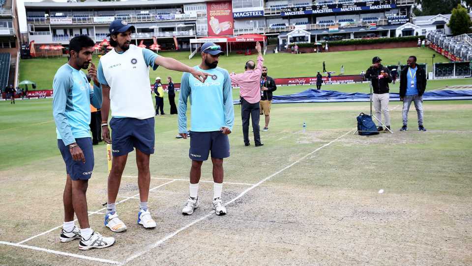 Jasprit Bumrah, Ishant Sharma and Mohammed Shami look at the pitch before the day's play