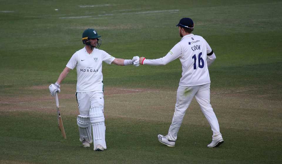 Jake Libby and Sam Cook punch gloves at the end of Worcestershire's innings