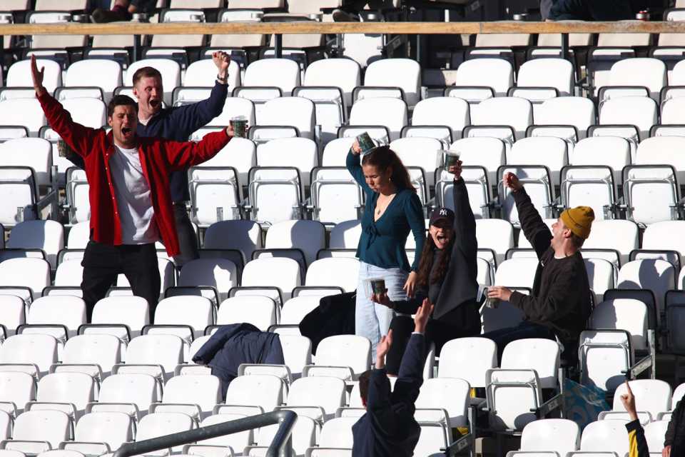 Celebrations at The Oval as a fan downs her pint, Surrey vs Middlesex, LV= Insurance Championship, Kia Oval, 3rd day, May 22, 2021