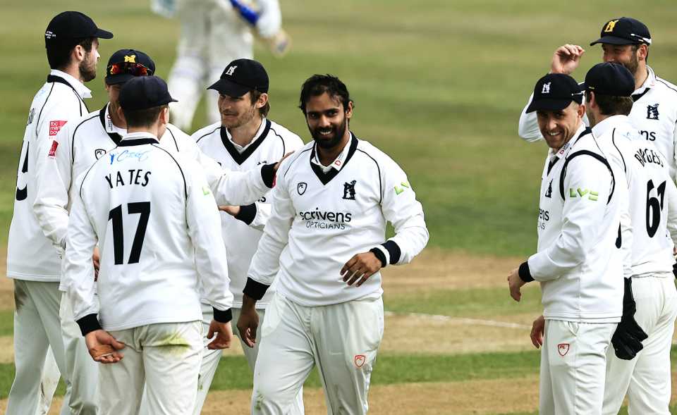 Hanuma Vihari celebrates with his Warwickshire team-mates after catching Steven Mullaney