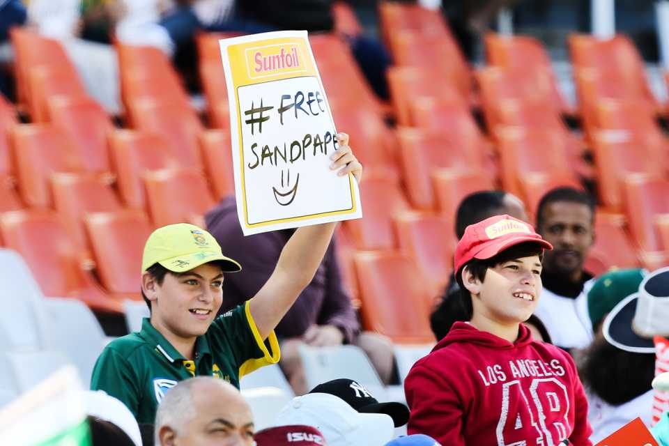 A spectator holds up a "Free sandpaper" sign, South Africa v Australia, 3rd Test, Cape Town, 4th day, March 25, 2018