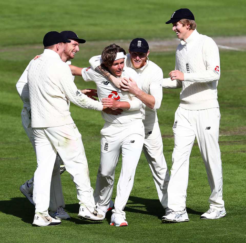 Sam Curran gets a hug from Ben Stokes and congratulations from his other team-mates for taking Shamarh Brooks' wicket