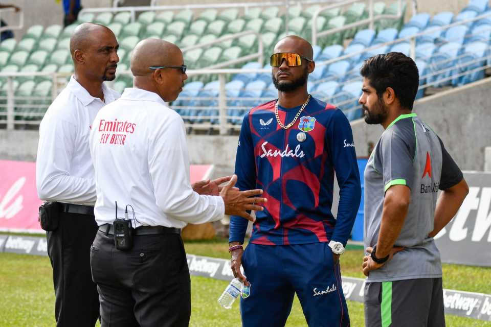 The umpires, Gregory Brathwaite and Joel Wilson, speak to rival captains Kraigg Brathwaite and Babar Azam about cancelling the day's play