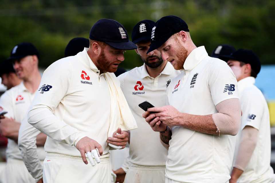 Jonny Bairstow, Mark Wood and Ben Stokes look at a phone, West Indies v England, 3rd Test, St Lucia, 4th day, February 12, 2019