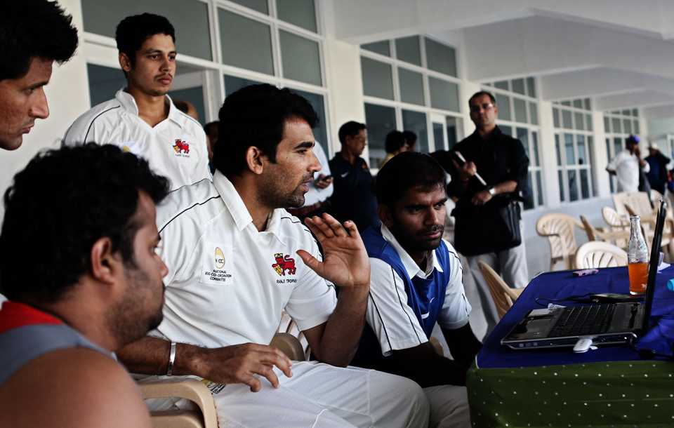 Zaheer Khan watches a video of his bowling action on a computer