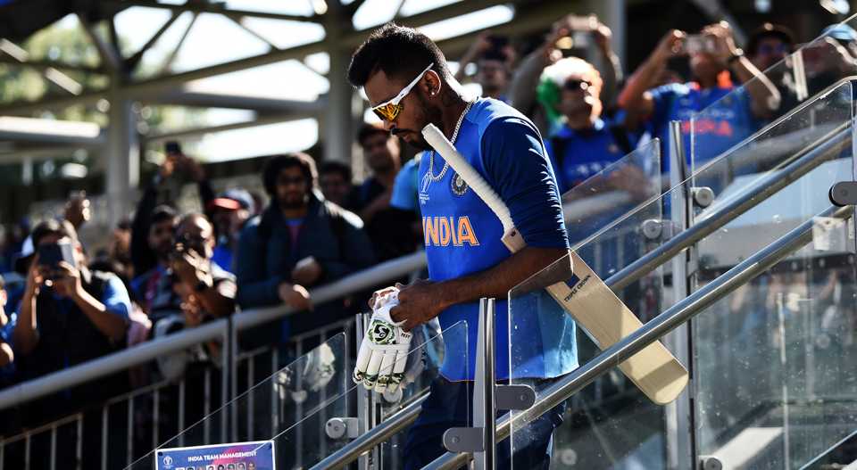 Hardik Pandya walks down the stairs to warm up while fans watch from the side