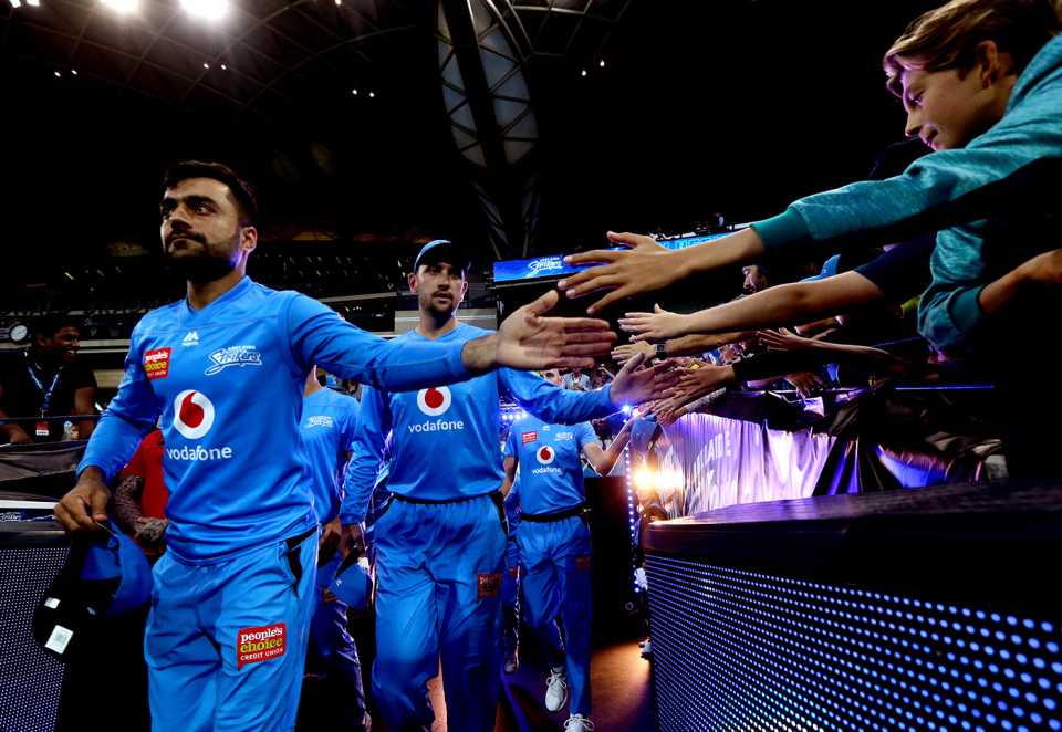Rashid Khan and the other Adelaide Strikers' players high-five fans