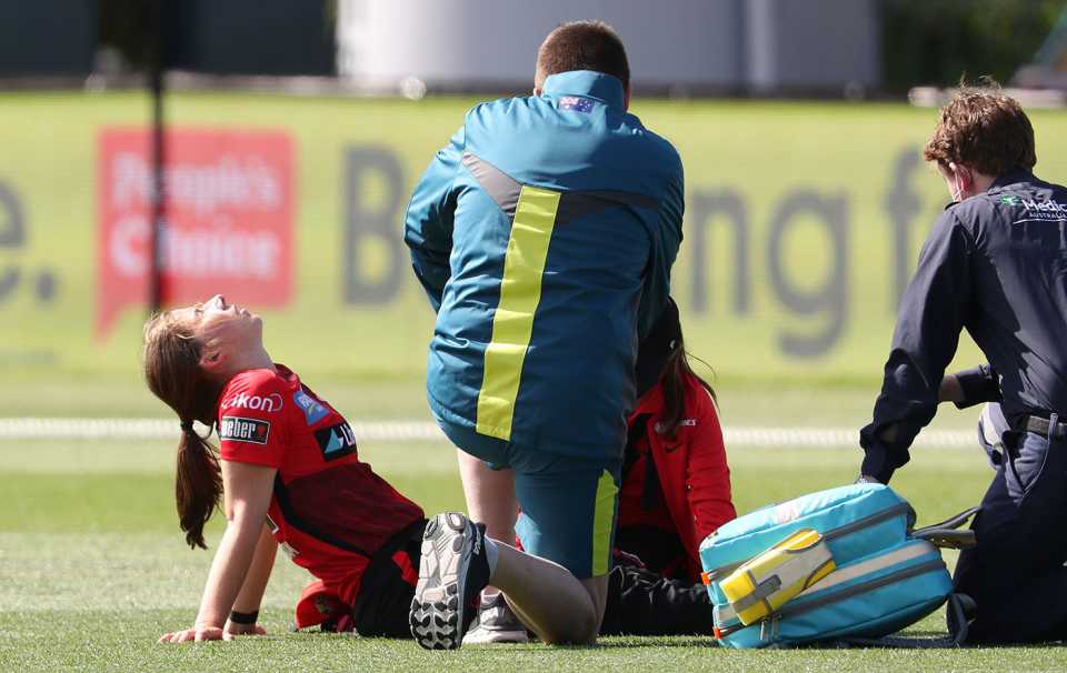 Georgia Wareham is helped by medics after hurting herself in the outfield