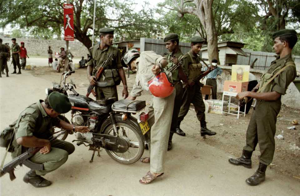 Sri Lankan soldiers check a motorcycle outside the SCC