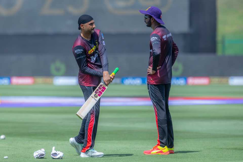 Venkatesh Iyer chats with Harbhajan Singh before the start of the match