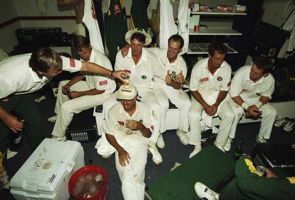 Mike Procter places a beer can on Hansie Cronje's head while South Africa celebrate their win over Australia in the dressing room