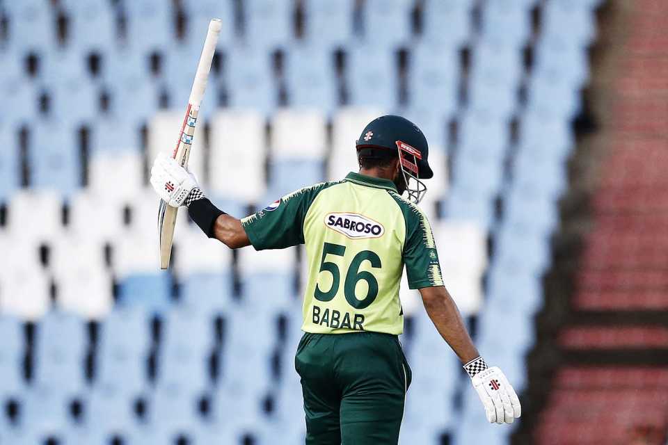 Babar Azam raises his bat after reaching his half-century