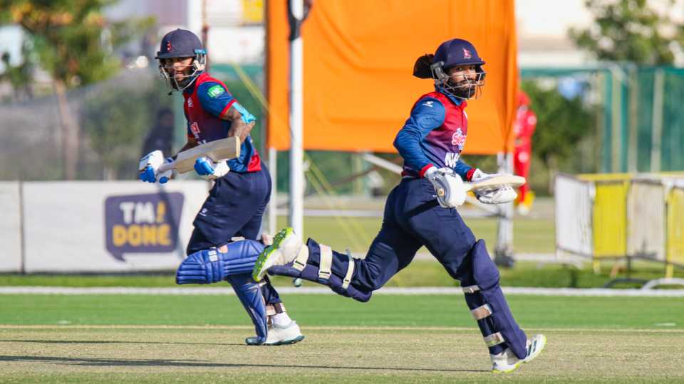Kushal Bhurtel (l) and Dipendra Singh Airee (r) run between the wickets during their 58-run partnership, Canada v Nepal, ICC Men's T20 World Cup Qualifier A, Al Amerat, February 21, 2022