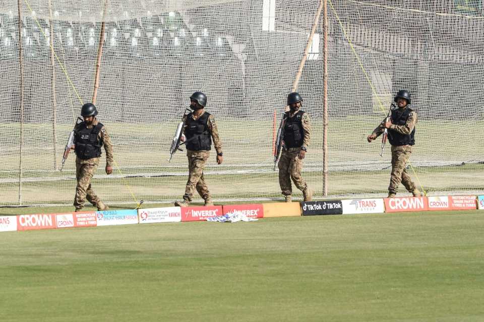 Pakistani army soldiers walk on the sidelines of the training sessions