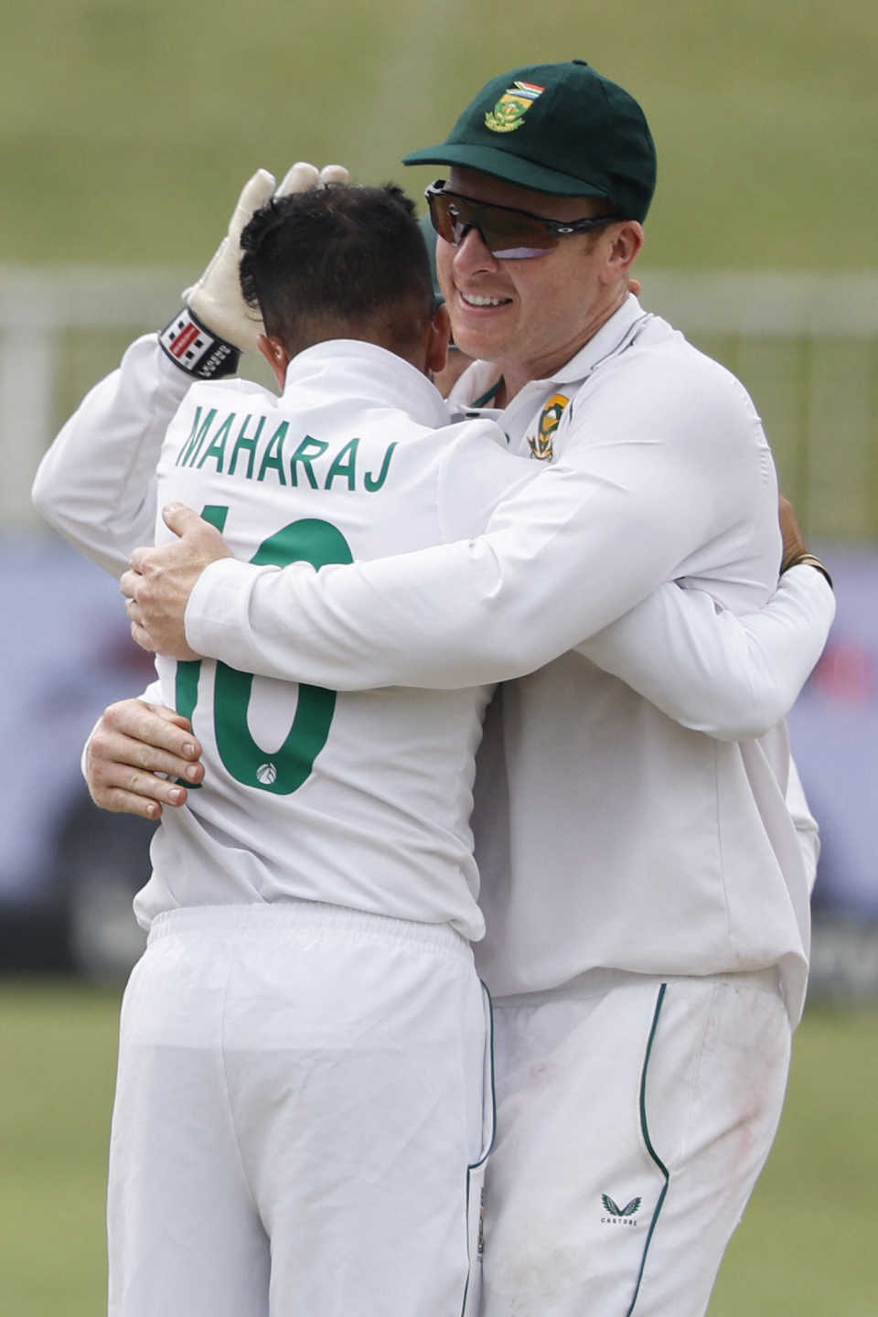 Keshav Maharaj and Simon Harmer celebrate a wicket, Durban, April 4, 2022