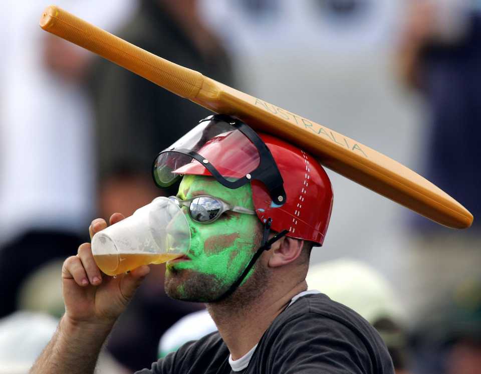 An Australian fan sports an unusual hat as he drinks a beer and watches play,  day two, second Test, Australia vs Sri Lanka, Cairns, July 10, 2004. 
