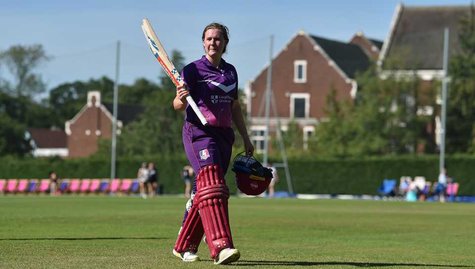 Kathryn Bryce raises her bat after she scores 109 not out