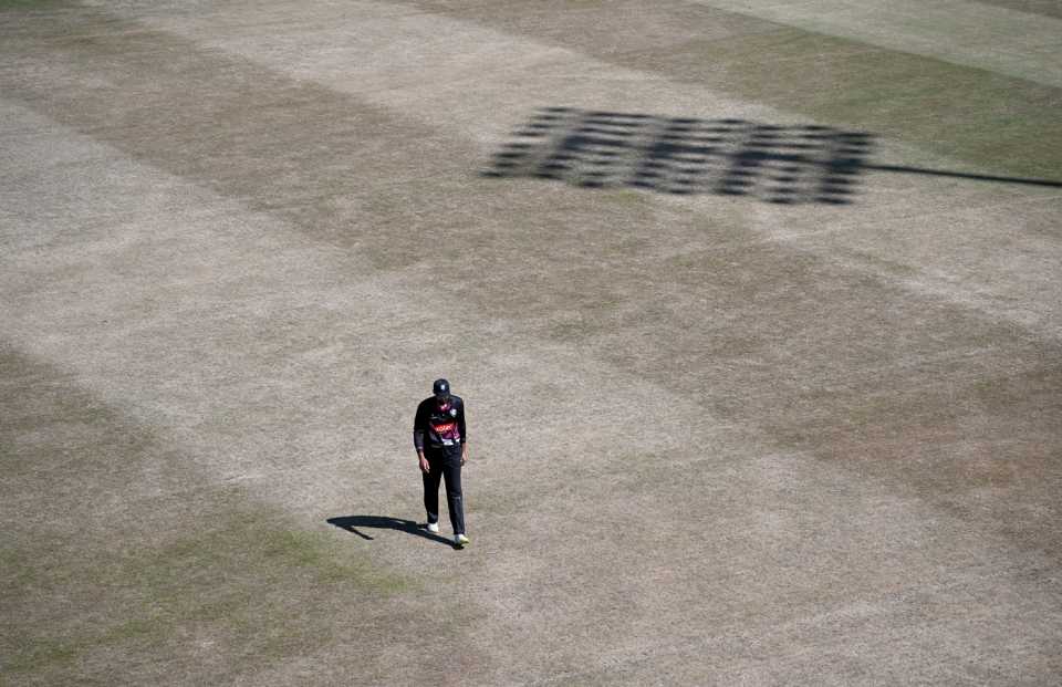 Andrew Umeed walks across a parched Leicester outfield during England's worst drought for nearly 30 years