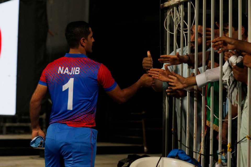 Najibullah Zadran shakes hands with fans after finishing the game