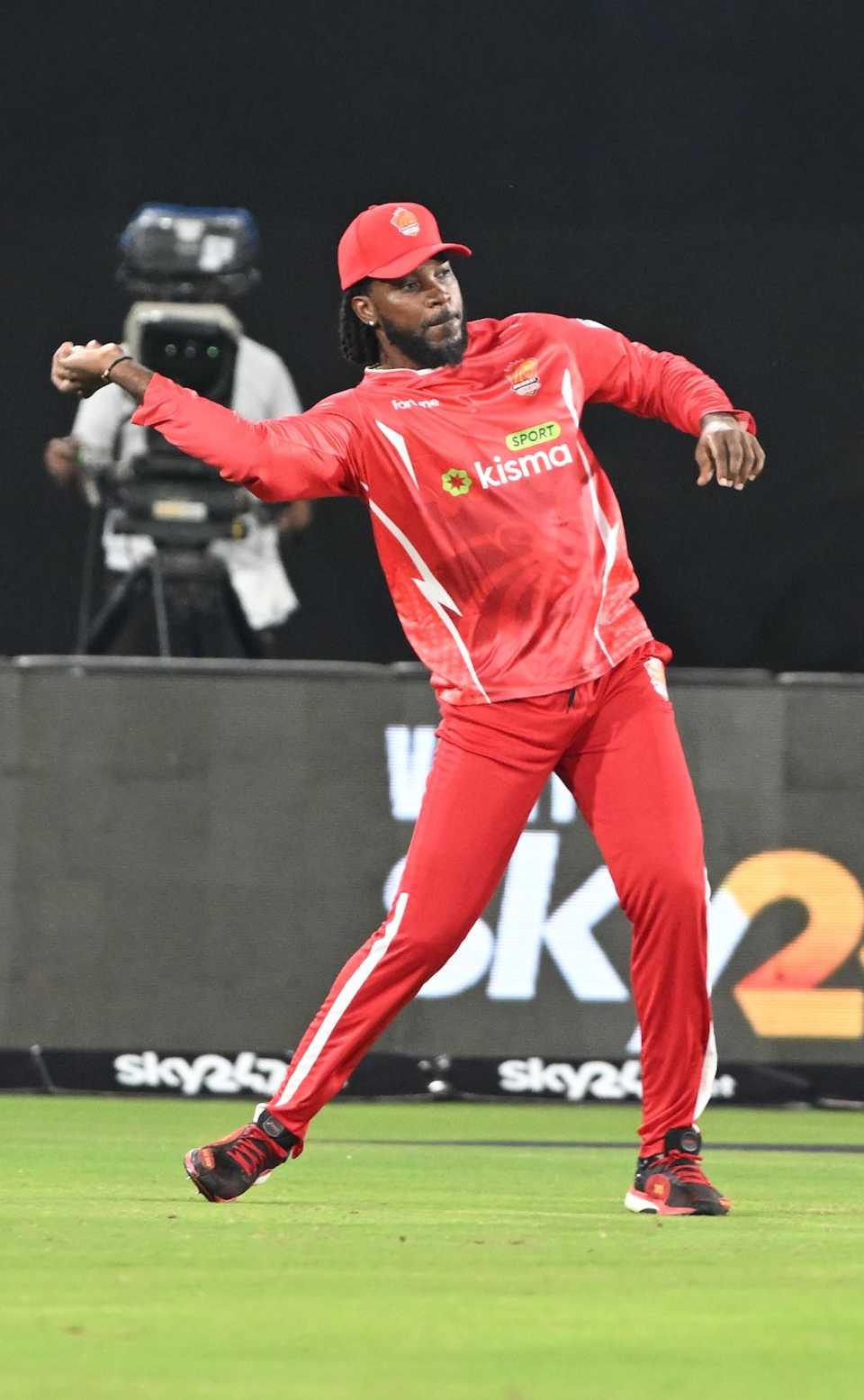 Chris Gayle throws the ball back