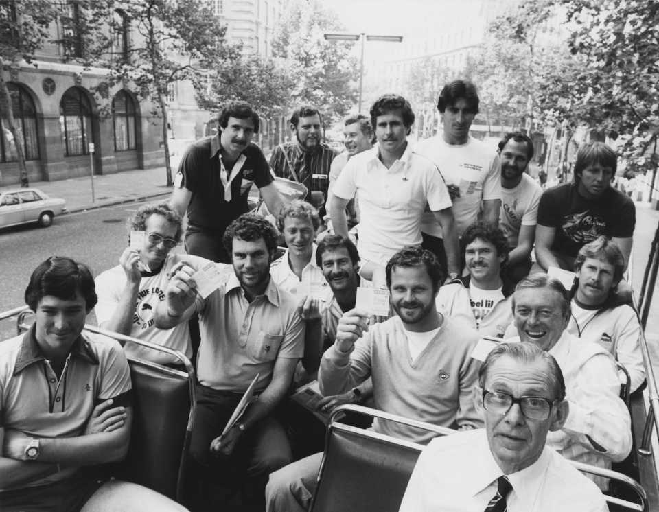 The Australian cricket team show their complimentary bus passes atop a double-decker tourist bus, London, August 26, 1980