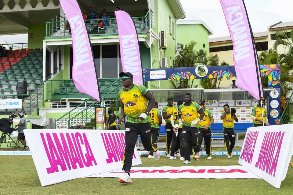 Rovman Powell leads the Jamaica Tallawahs' players out onto the field