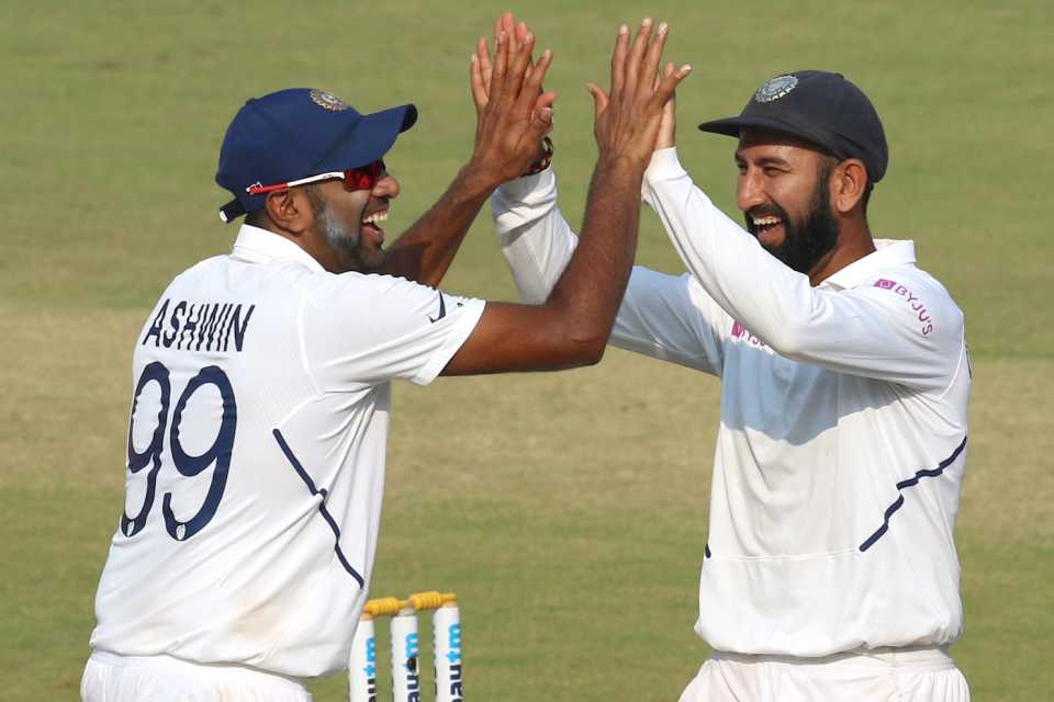 R Ashwin and Cheteshwar Pujara celebrate a wicket