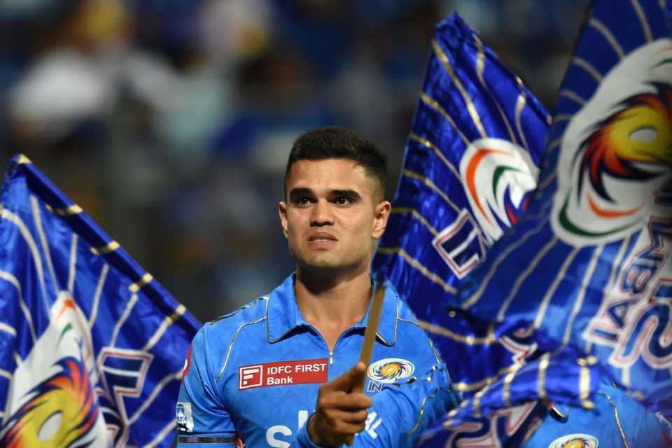 Arjun Tendulkar is surrounded by the Mumbai Indians flag after making his IPL debut