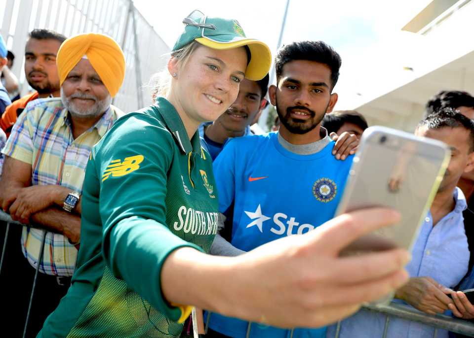 Dane van Niekerk takes selfies with fans after the match against India