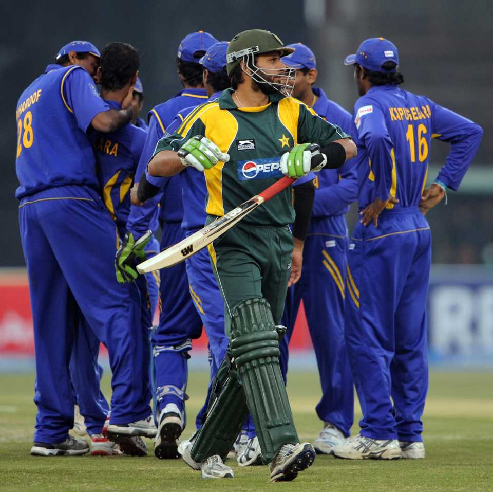 Shahid Afridi walks back after being bowled