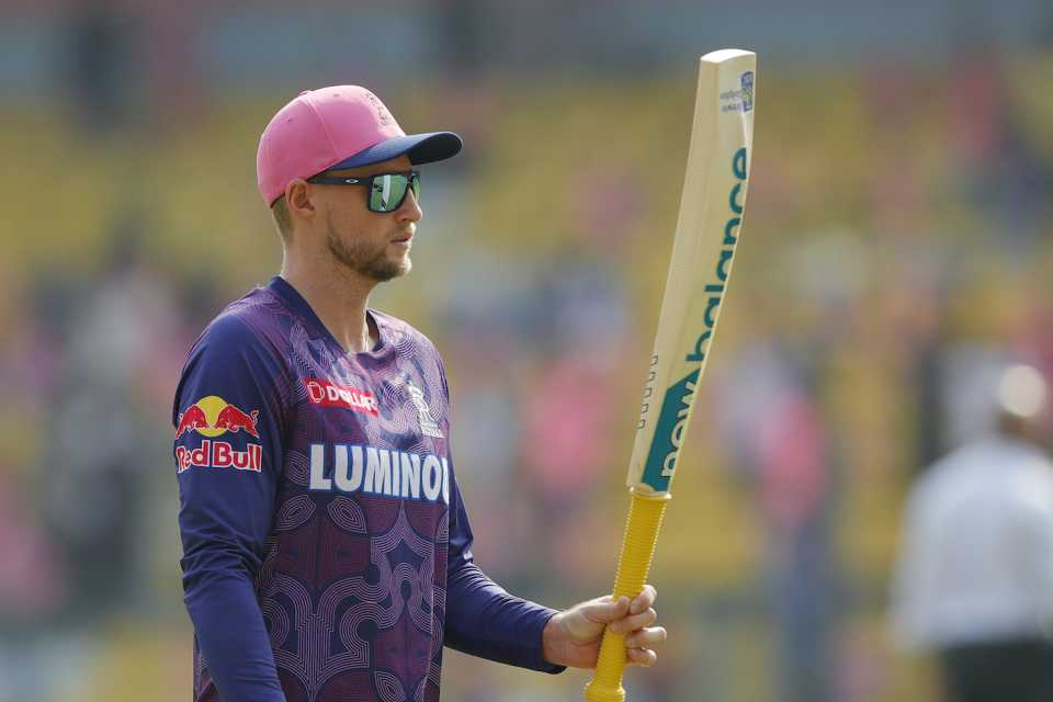 Joe Root tests the heft of a bat before the game