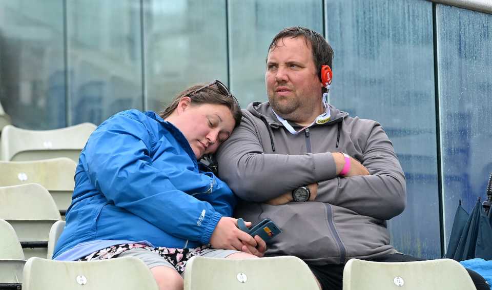 A couple of fans cope with the rain at the stadium, England vs Australia, 1st Ashes Test, Edgbaston, 5th day, June 20, 2023