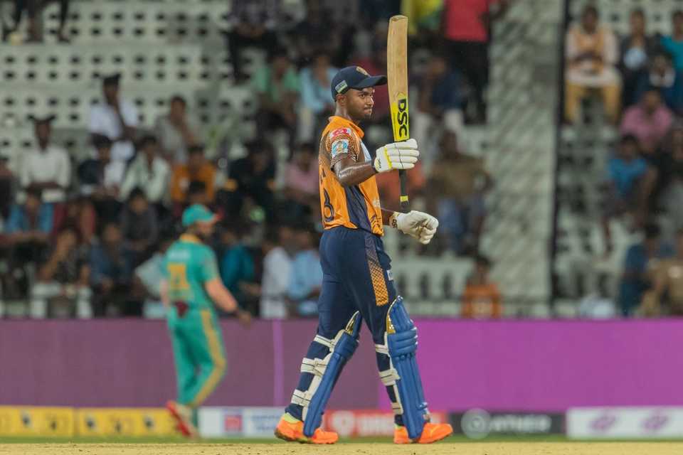 G Ajitesh raises his bat after reaching a half-century