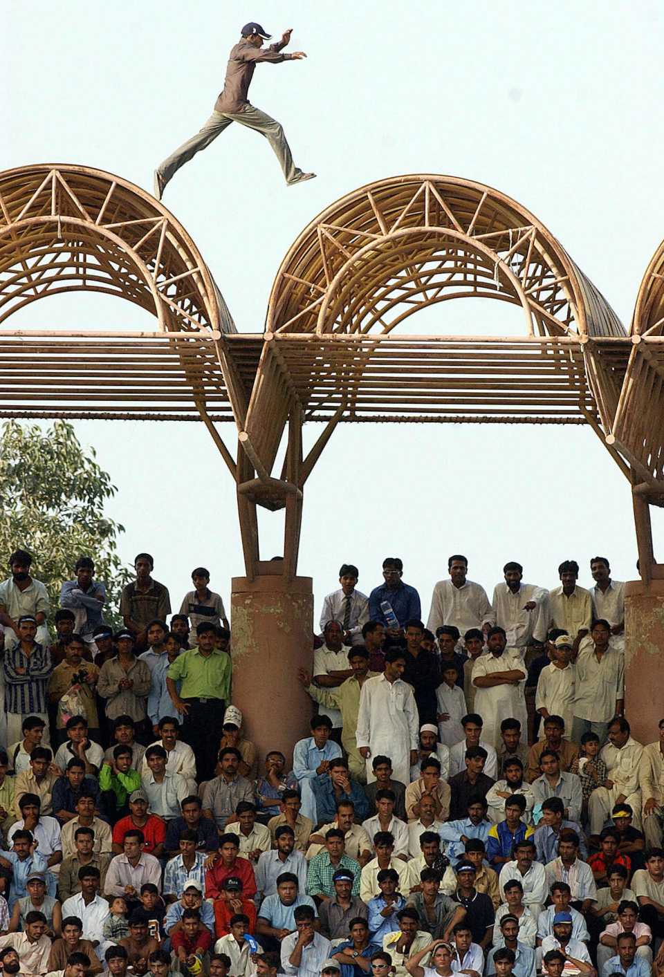 A cricket fan jumps on the roof of a shade, third ODI, Pakistan vs Bangladesh, Lahore,  September 15 2003
