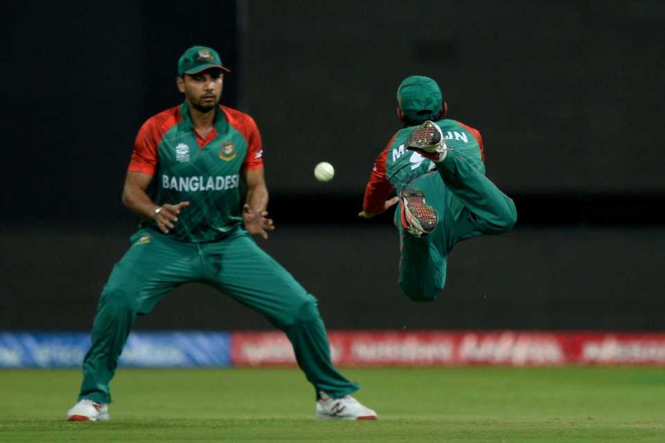Mohammed Mithun dives in an attempt to take a catch while team captain Mashrafe Mortaza watches