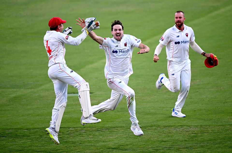 Jordan Buckingham is chased by team-mates after claiming the winning wicket, Queensland vs South Australia, Sheffield Shield, Gabba, November 9, 2023