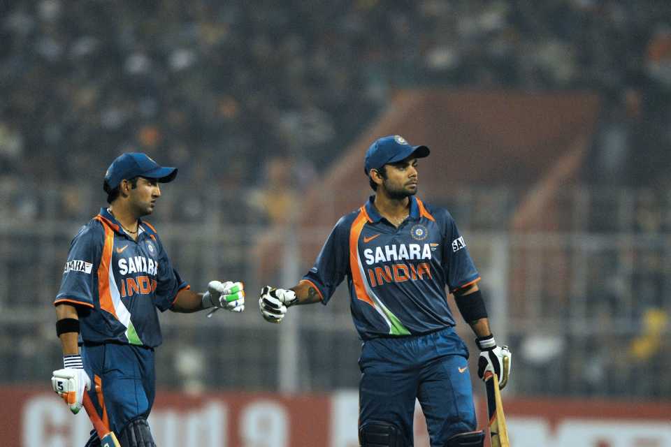 Virat Kohli celebrates a boundary with Gautam Gambhir on the way to his maiden ODI hundred