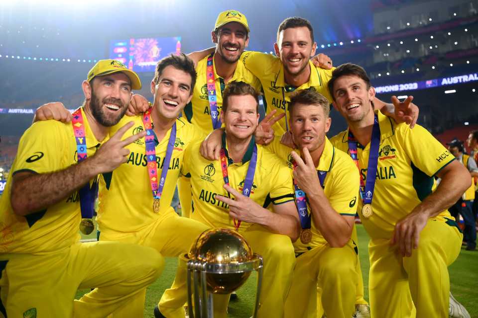 Two-time ODI World Cup winners - Glenn Maxwell, Pat Cummins, Mitchell Starc, Steven Smith, Josh Hazlewood, David Warner, and Mitchell Marsh - strike a pose with the trophy