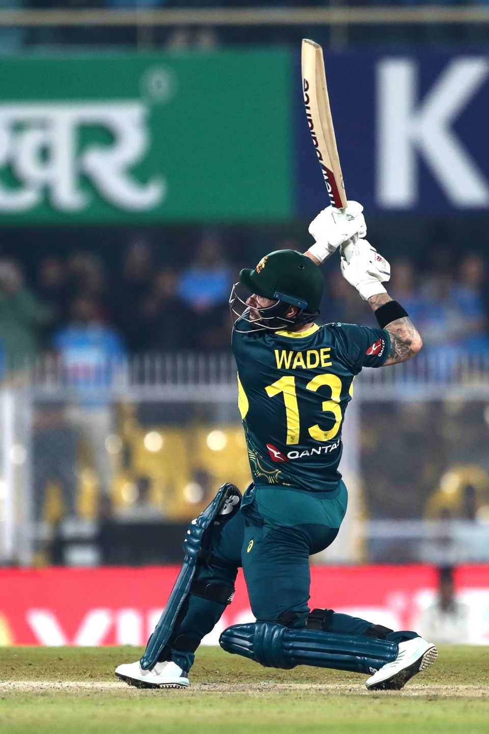 There it goes: Mathew Wade launches the ball back
