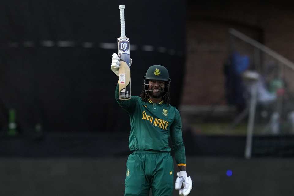 Tony de Zorzi raises his bat after scoring fifty