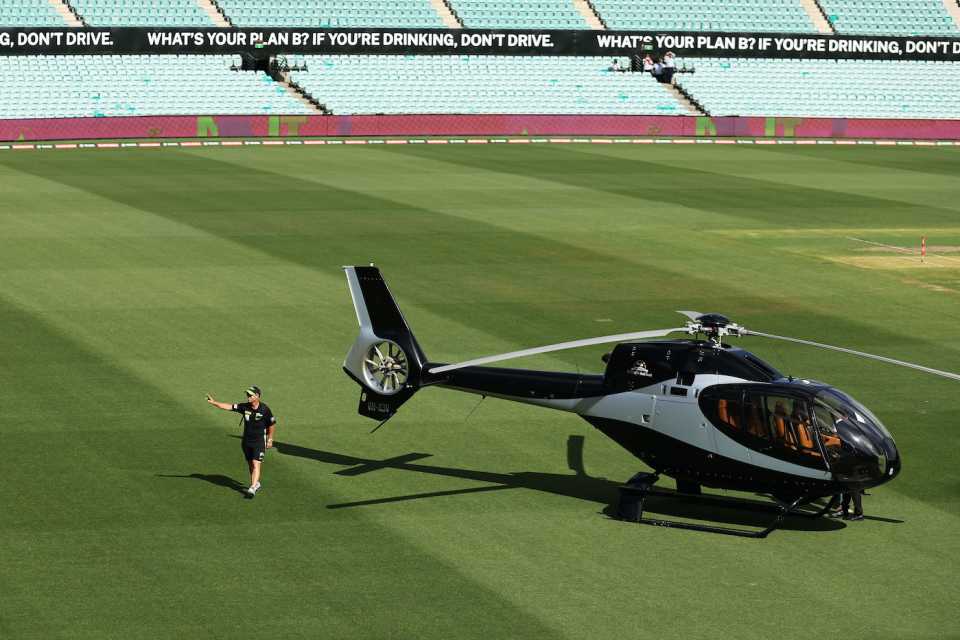 David Warner waves after his helicopter landed on the SCG outfield